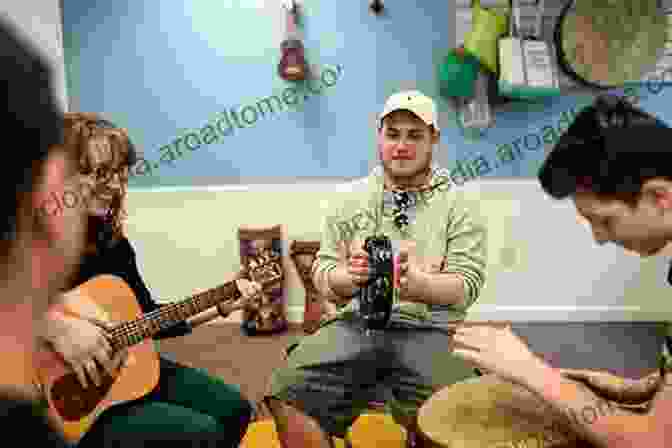 Music Therapist Playing Guitar With A Group Of Clients Crafts And Creative Media In Therapy Fifth Edition